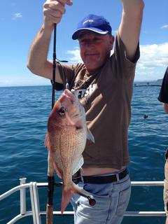 Excited Customer holds up a snapper