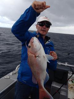 Customer posing with a snapper in Auckland